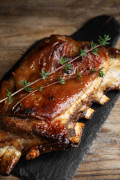 Photo of Delicious roasted ribs served on wooden table