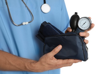 Male doctor holding blood pressure meter on white background, closeup. Medical object