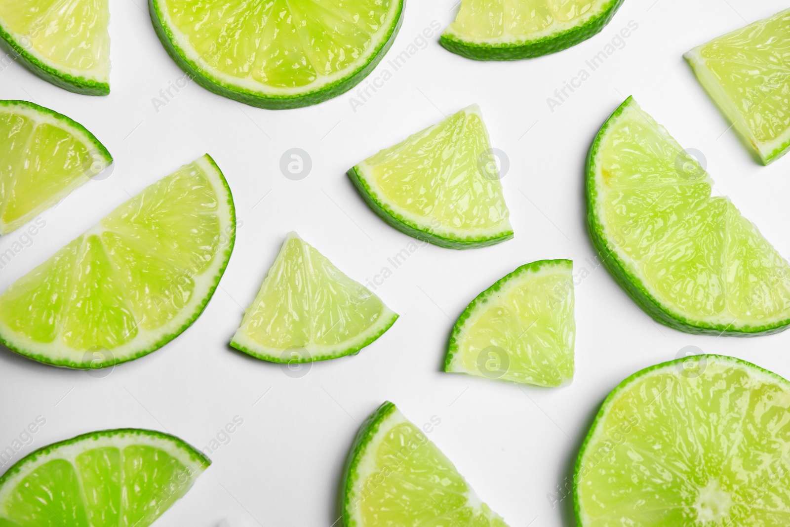 Photo of Juicy fresh lime slices on white background, top view