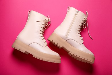 Photo of Pair of stylish leather shoes on pink background, flat lay