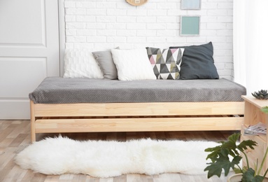 Modern living room interior with wooden furniture and furry carpet