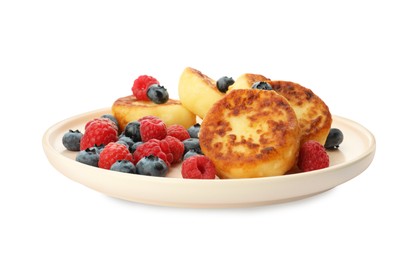 Photo of Plate with delicious cottage cheese pancakes and fresh berries on white background