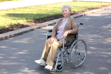 Photo of Senior woman in wheelchair at park on sunny day