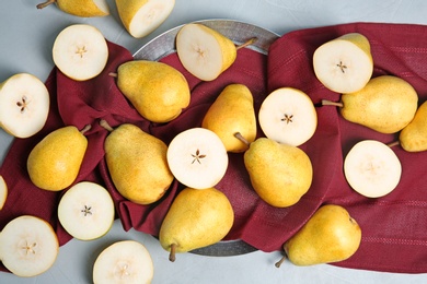 Flat lay composition with fresh ripe pears and fabric on gray background