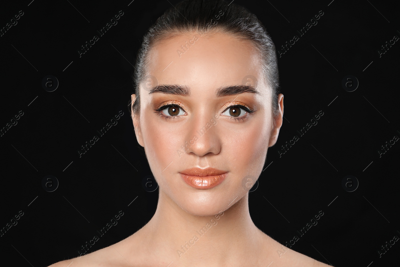 Photo of Beautiful young woman with glitter makeup on black background