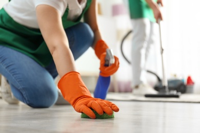 Photo of Woman cleaning floor with sponge, closeup. Space for text