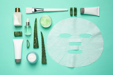 Photo of Flat lay composition with different cosmetic products and aloe on turquoise background