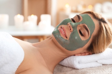 Photo of Beautiful woman with mask on face relaxing in spa salon