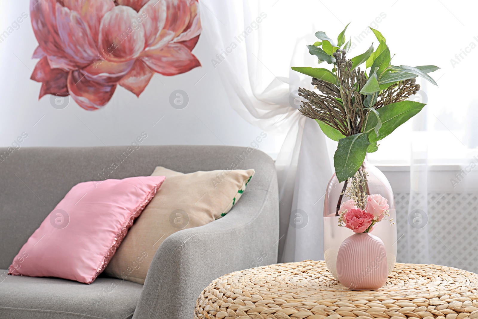 Photo of Vases with beautiful bouquets on table in room interior