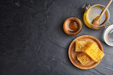 Photo of Flat lay composition with delicious honey on black table. Space for text