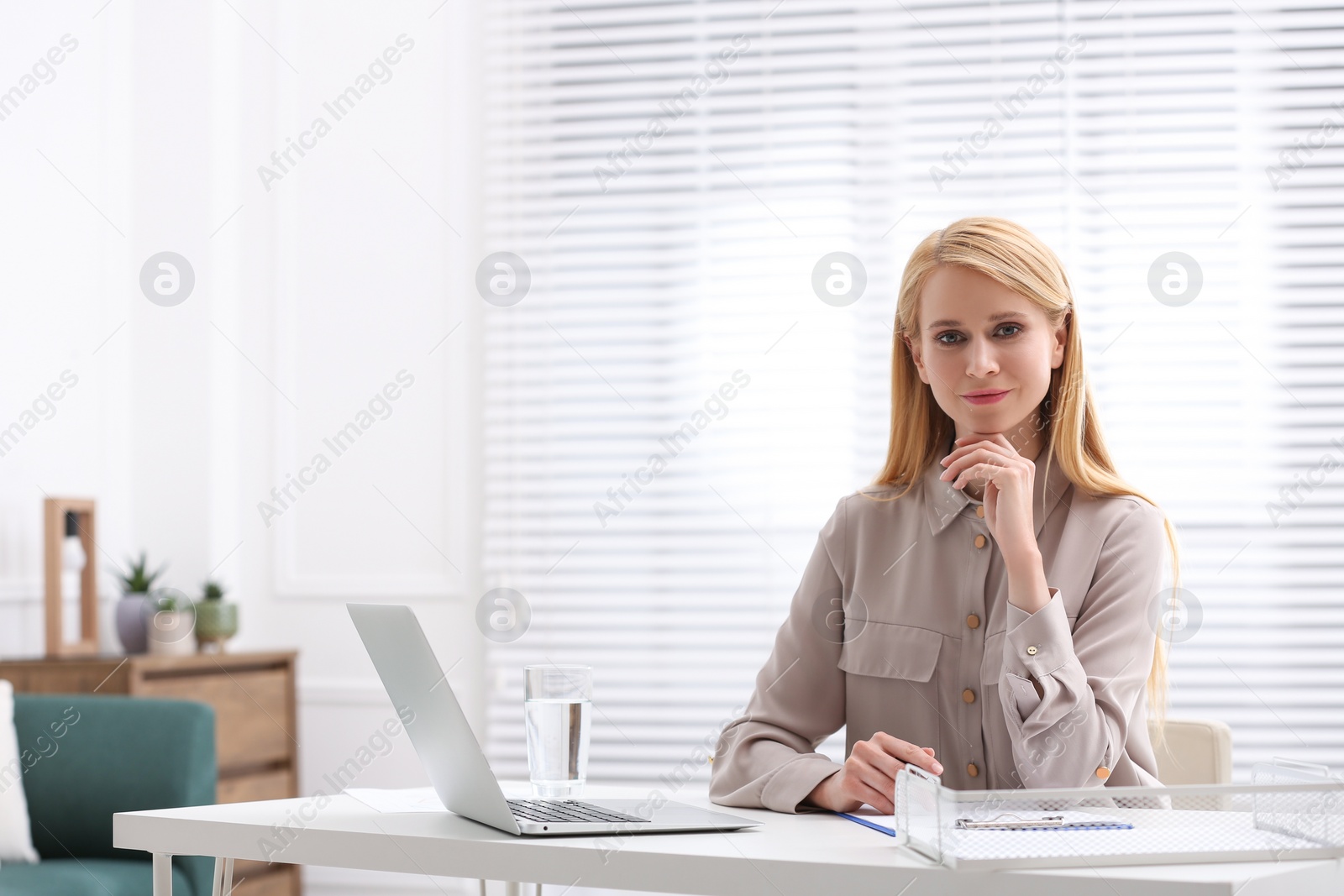 Photo of Professional lawyer working on laptop at table in office