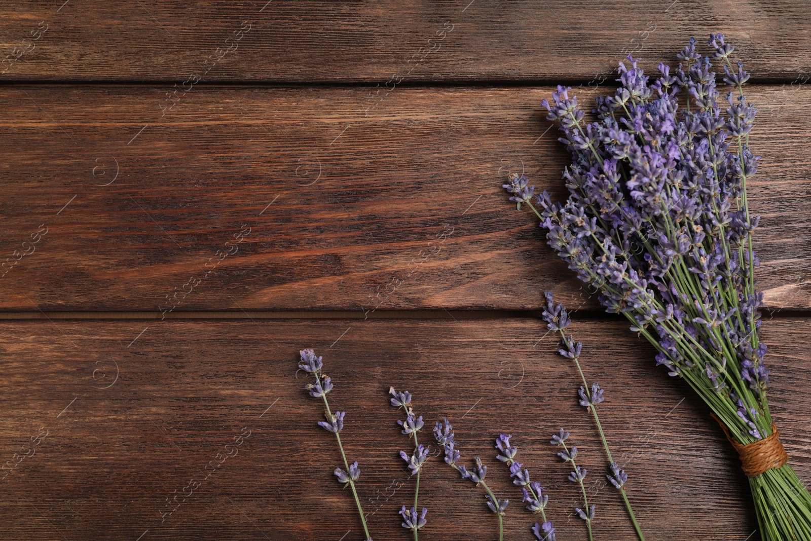 Photo of Beautiful lavender flowers on wooden background, flat lay. Space for text