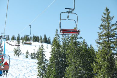 Photo of Ski lift at mountain resort. Winter vacation