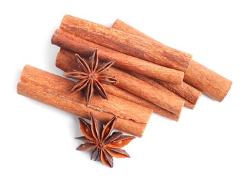 Aromatic cinnamon sticks and anise stars isolated on white, top view