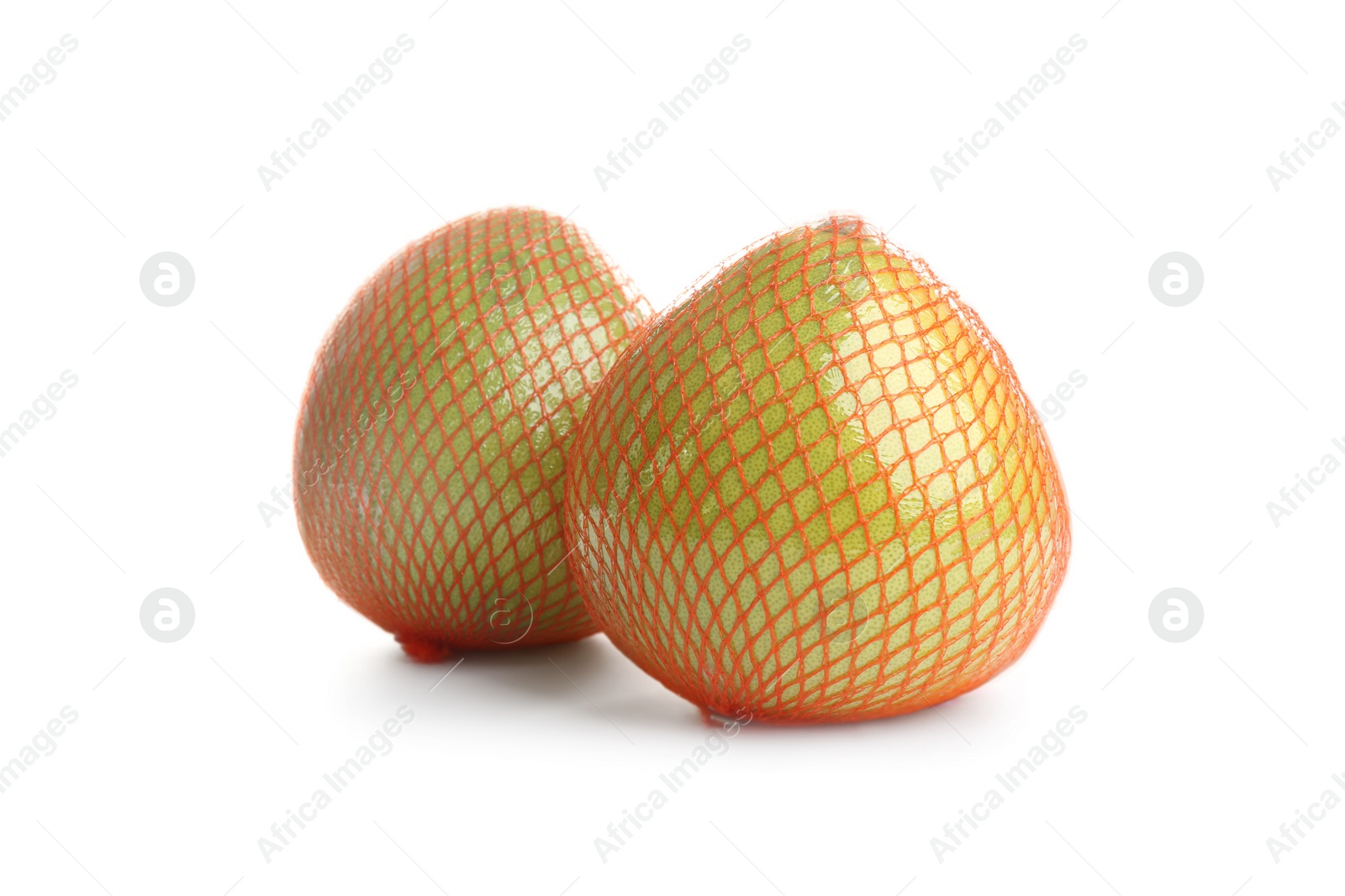 Photo of Fresh pomelo fruits in meshes isolated on white