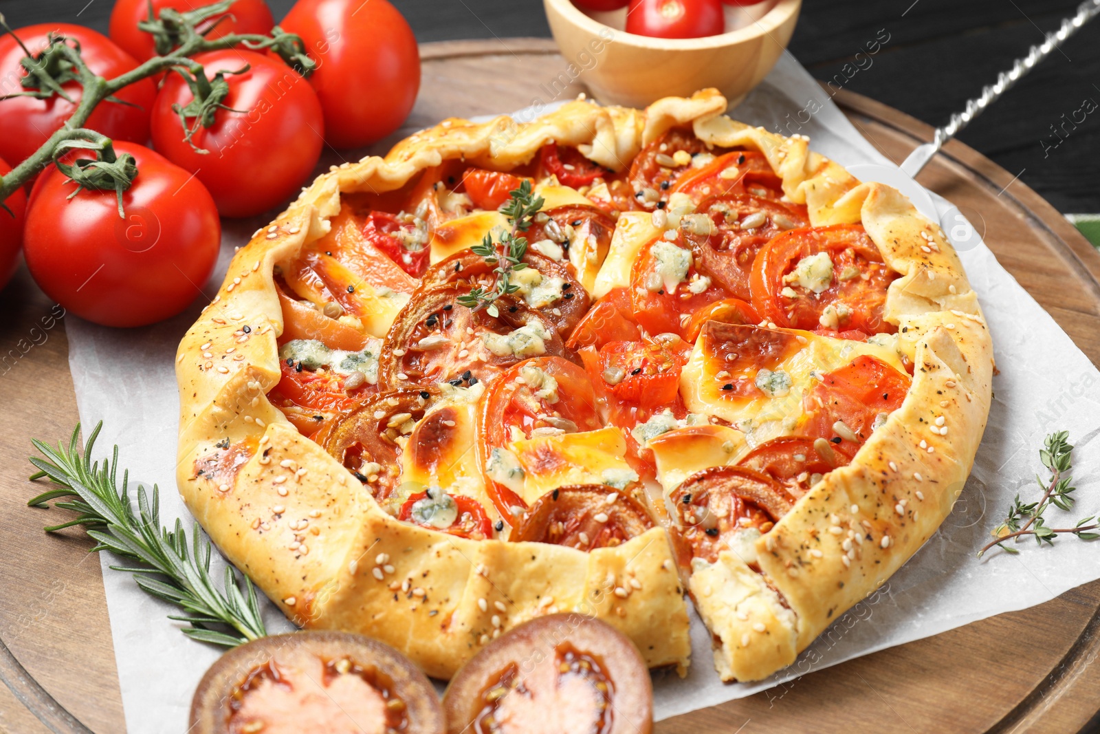 Photo of Tasty galette with tomato and cheese (Caprese galette) on table, closeup