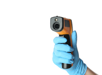 Doctor in latex gloves holding non-contact infrared thermometer on white background, closeup