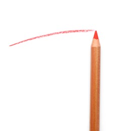 Photo of Red pastel pencil and scribble isolated on white, top view. Drawing supply