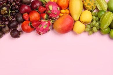 Photo of Assortment of fresh exotic fruits on pink background, flat lay. Space for text