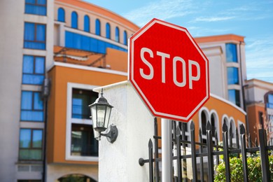 Photo of Post with Stop sign on city street