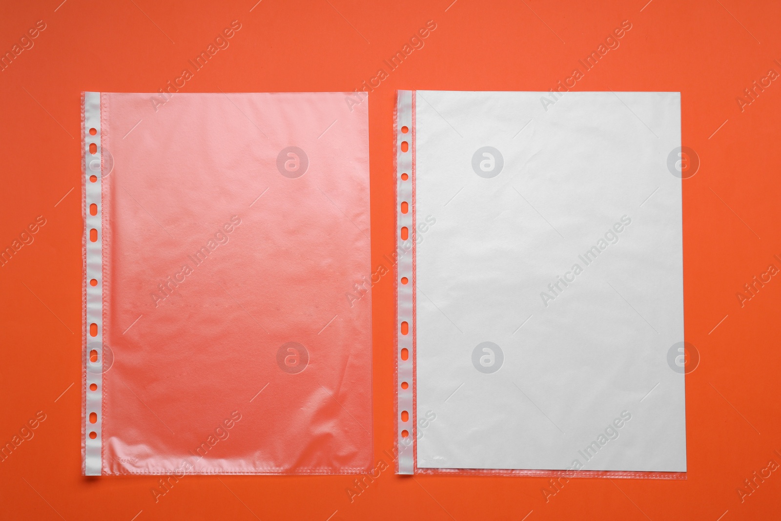 Photo of Punched pockets on orange background, flat lay. Space for text