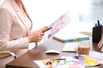 Photo of Female designer working at desk in office, closeup