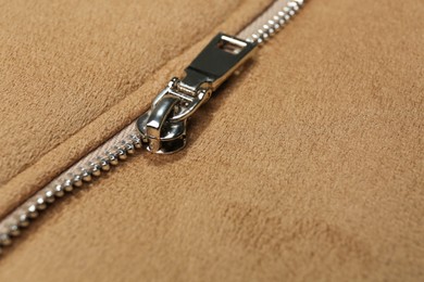 Photo of Beige jacket with zipper as background, closeup view