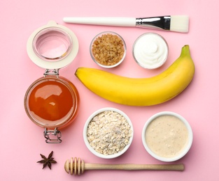 Different ingredients and handmade face mask on pink background, flat lay