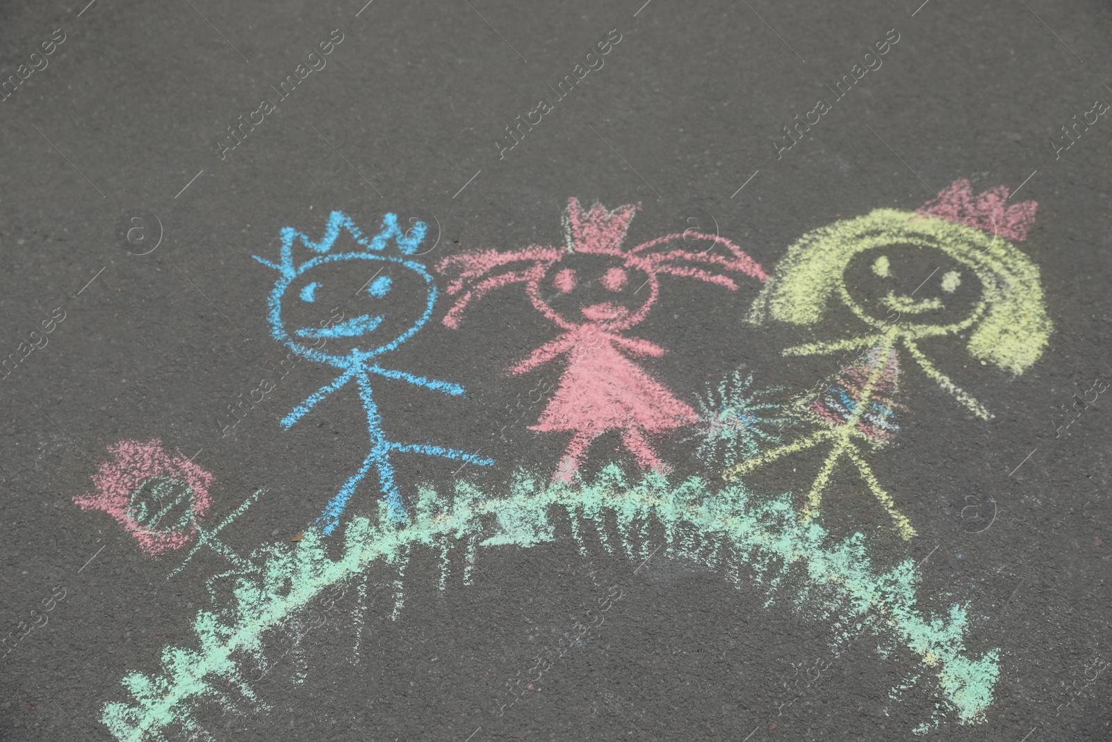 Photo of Child's chalk drawing of family on asphalt, above view