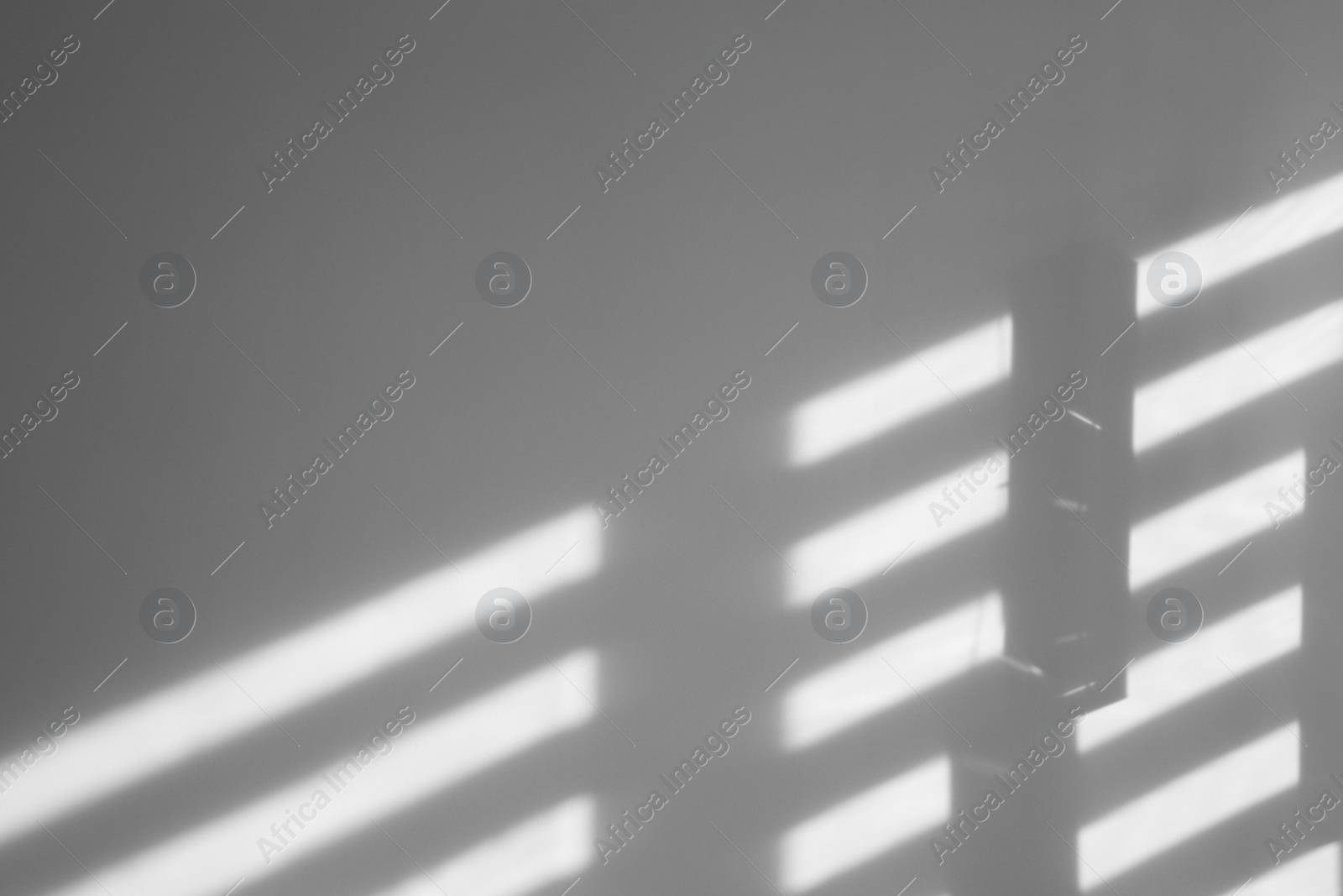 Photo of Lines made of light and shadows on white wall