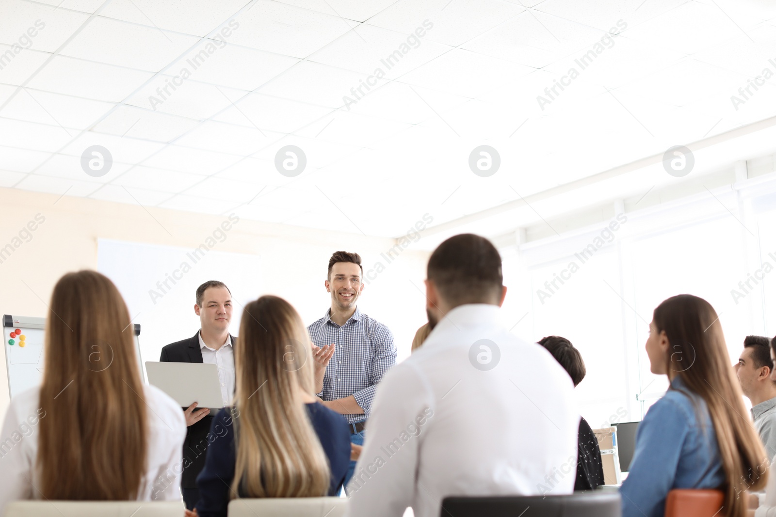 Photo of Business trainers giving lecture in office