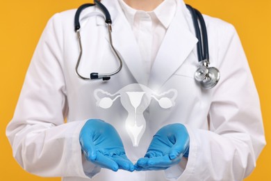 Doctor and illustration of female reproductive system on orange background, closeup