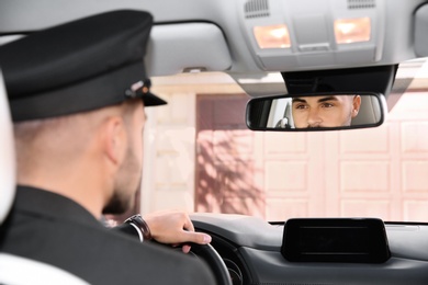 Photo of Young driver in luxury car. Chauffeur service