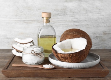 Photo of Composition with natural organic coconut oil on wooden table