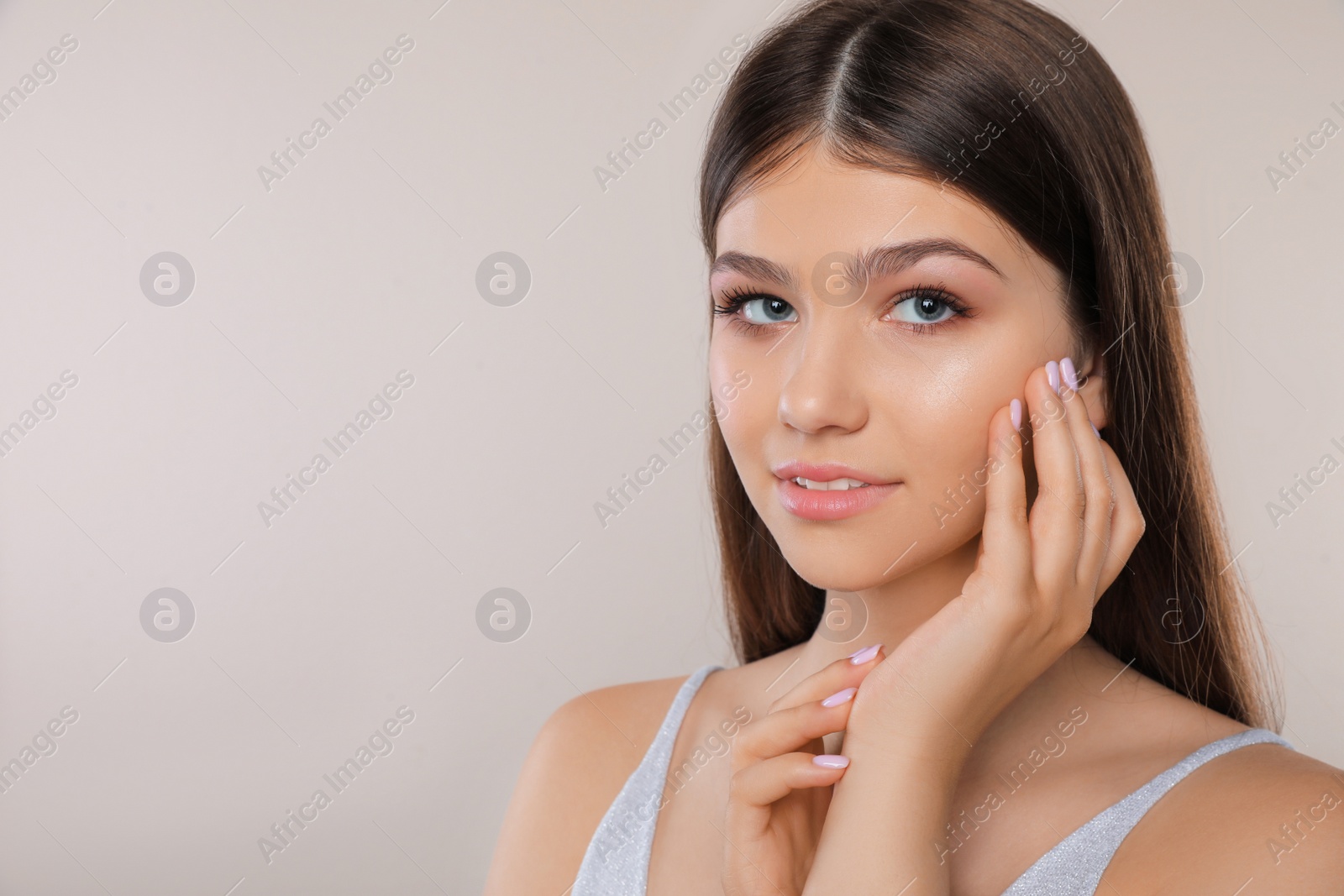 Photo of Portrait of pretty girl on light background, space for text. Beautiful face with perfect smooth skin