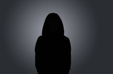 Silhouette of anonymous woman on dark background