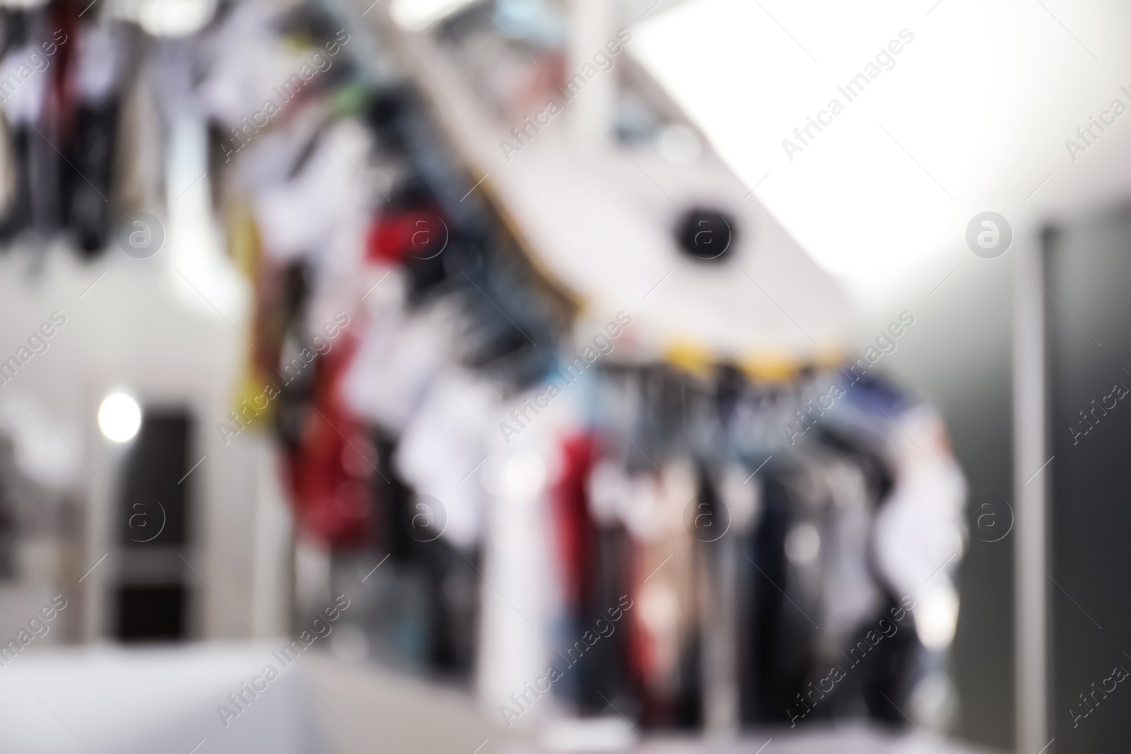 Photo of Blurred view of dry-cleaner's interior with garment conveyor