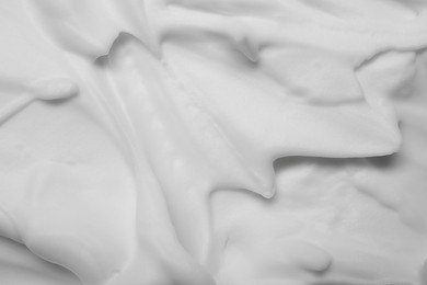 Photo of Texture of white shaving foam as background, closeup