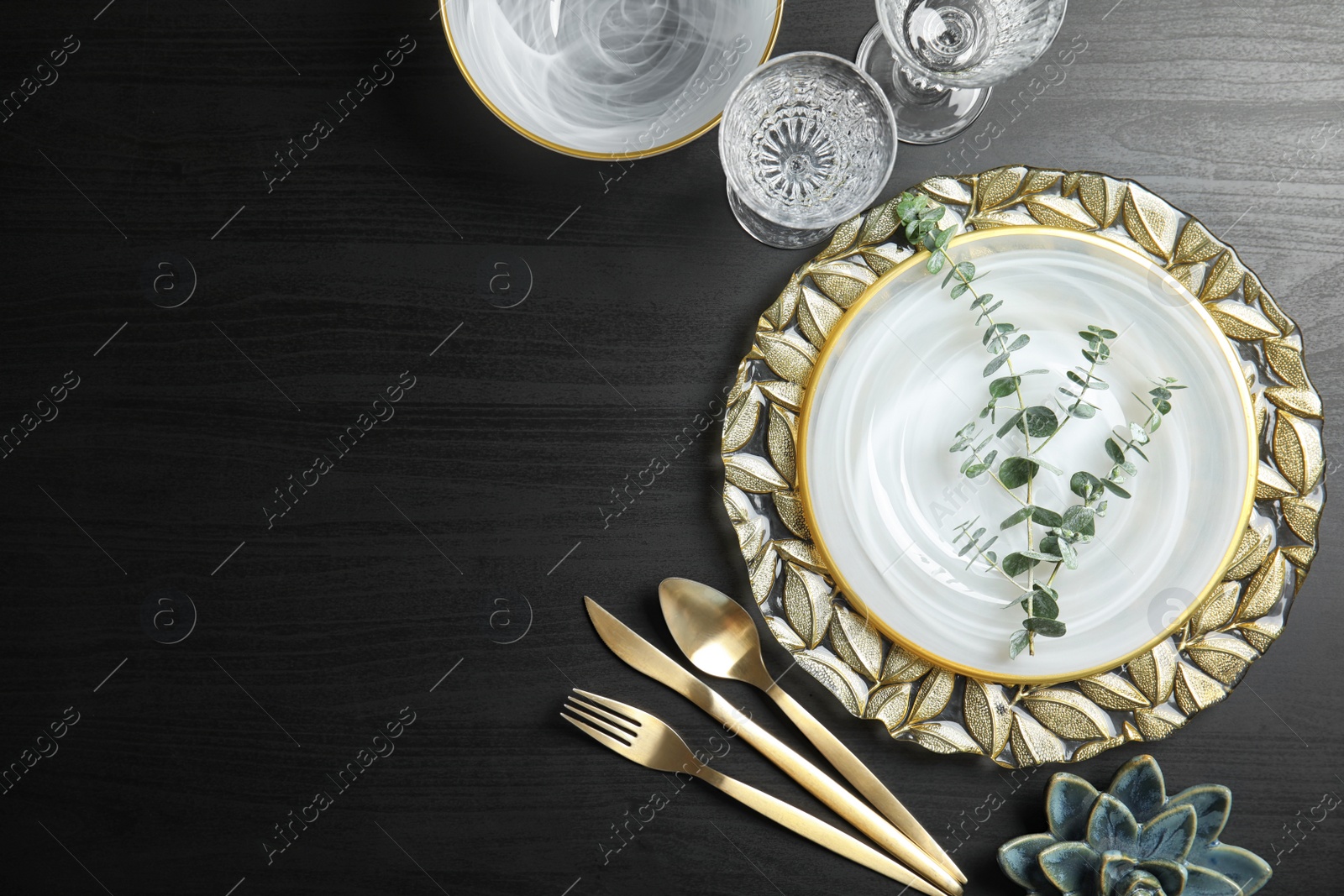 Photo of Elegant table setting and space for text on dark background, top view