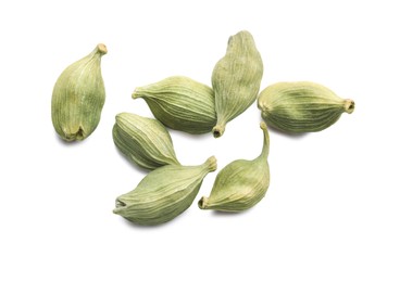 Photo of Pile of dry green cardamom pods on white background, top view