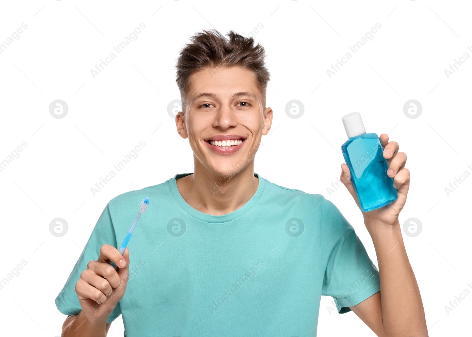 Photo of Young man with mouthwash and toothbrush on white background