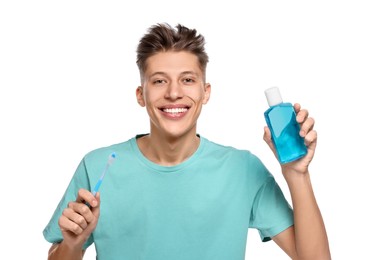 Photo of Young man with mouthwash and toothbrush on white background