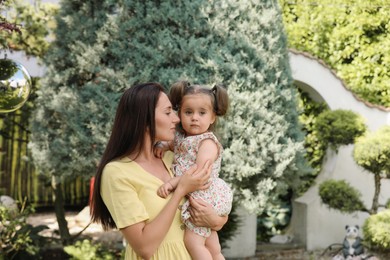 Photo of Mother with her cute daughter spending time together in park