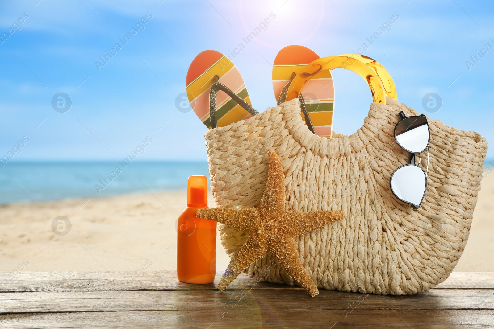 Image of Beach accessories on wooden surface near sea