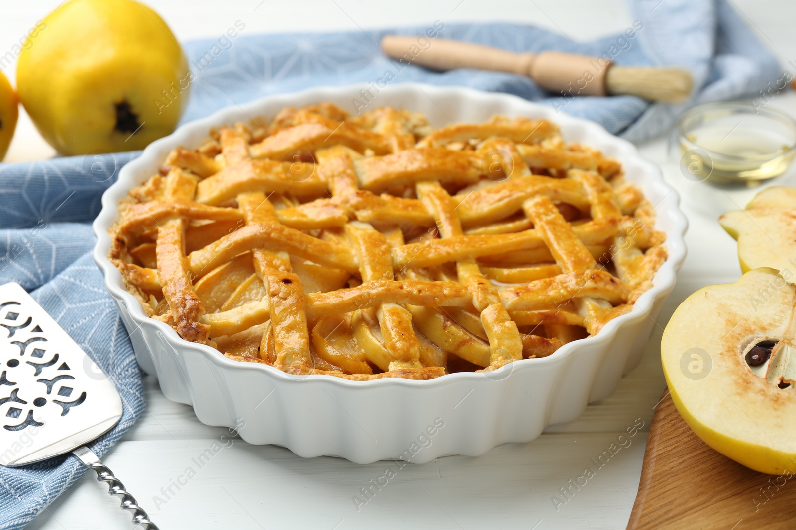 Photo of Tasty homemade quince pie on white wooden table, closeup