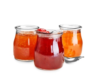 Three jars with tasty sweet jam on white background