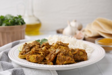 Photo of Delicious chicken curry with rice on table, closeup