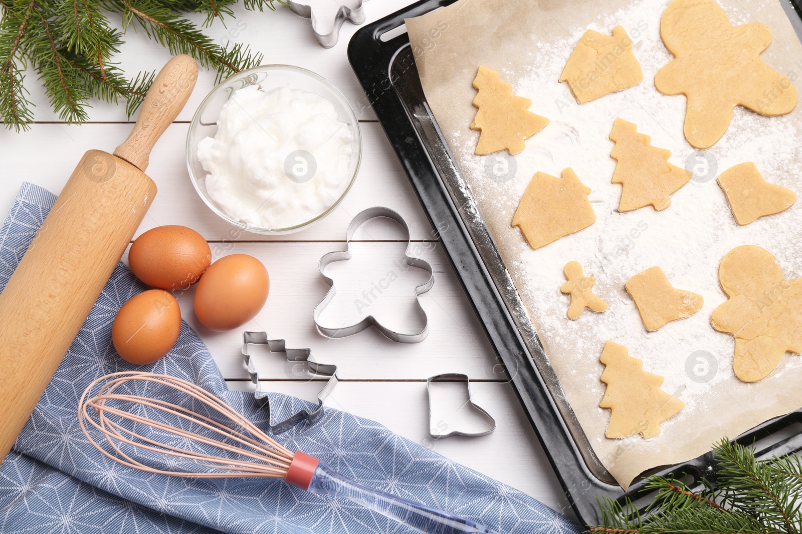 Photo of Making Christmas cookies. Flat lay composition with raw dough and ingredients on white wooden table