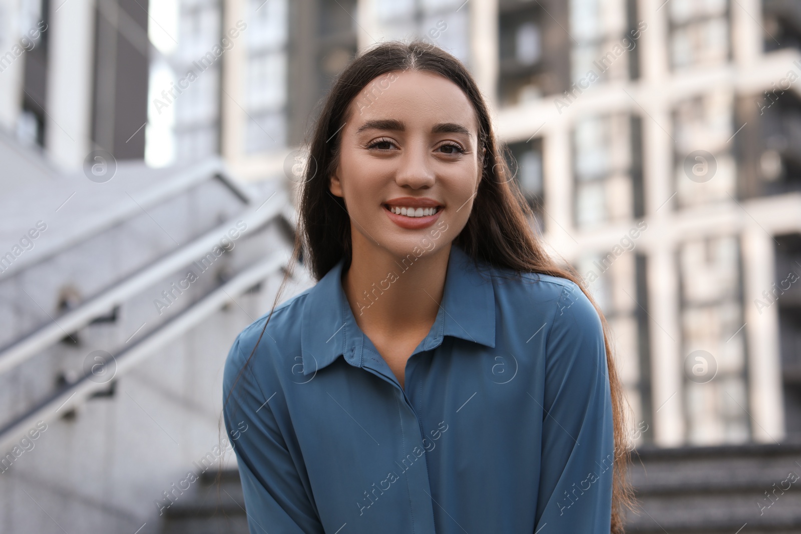 Photo of Portrait of beautiful woman outdoors. Attractive lady smiling and looking into camera