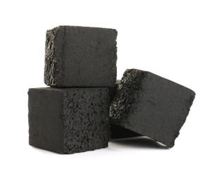 Photo of Stack of charcoal cubes for hookah on white background